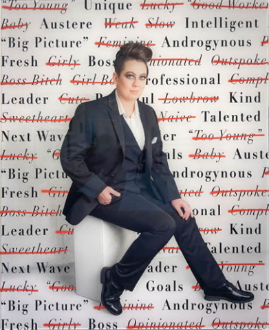 Photograph of a boss woman surrounded by complimentary text writing on a wall