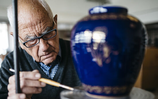 senior-man-decorating-ceramic-vase-in-his-spare-ti-CeramicRotation