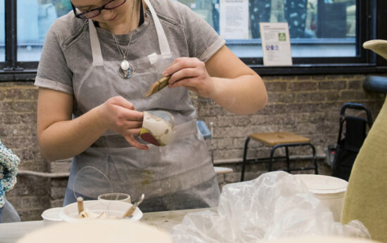 woman-in-art-studio-glazing-pottery-CeramicRotation