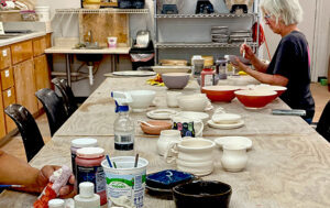 woman working independently in ceramics studio