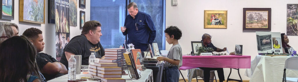 book author speaking with interested child at the 2024 literary fair