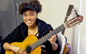young African-American girl playing the guitar