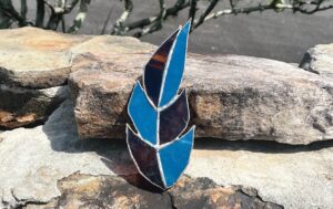 blue and brown glass feather