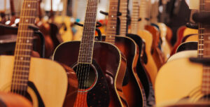 row of acoustic guitars with a beautiful wood tone