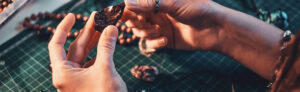 artist making unique jewelry with stones and metal