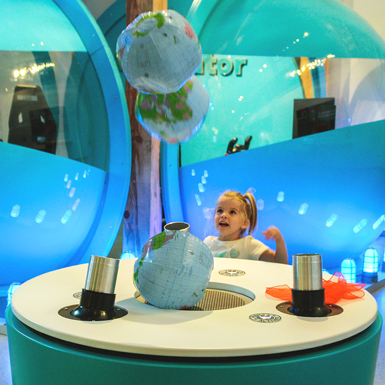 young girl plays with the gravity balloons at the imagination station